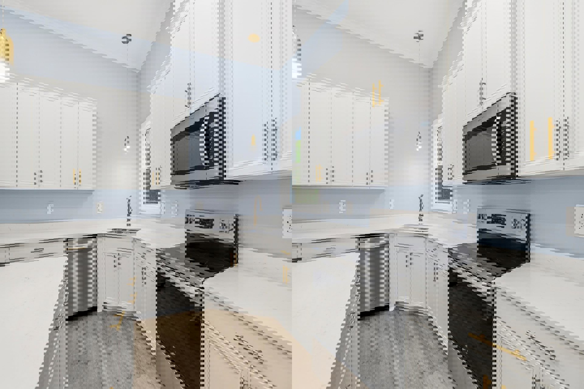 White kitchen with gold hardware, black stove and oven, built-in microwave, and white countertops; close-up view of dishwasher and cabinetry.