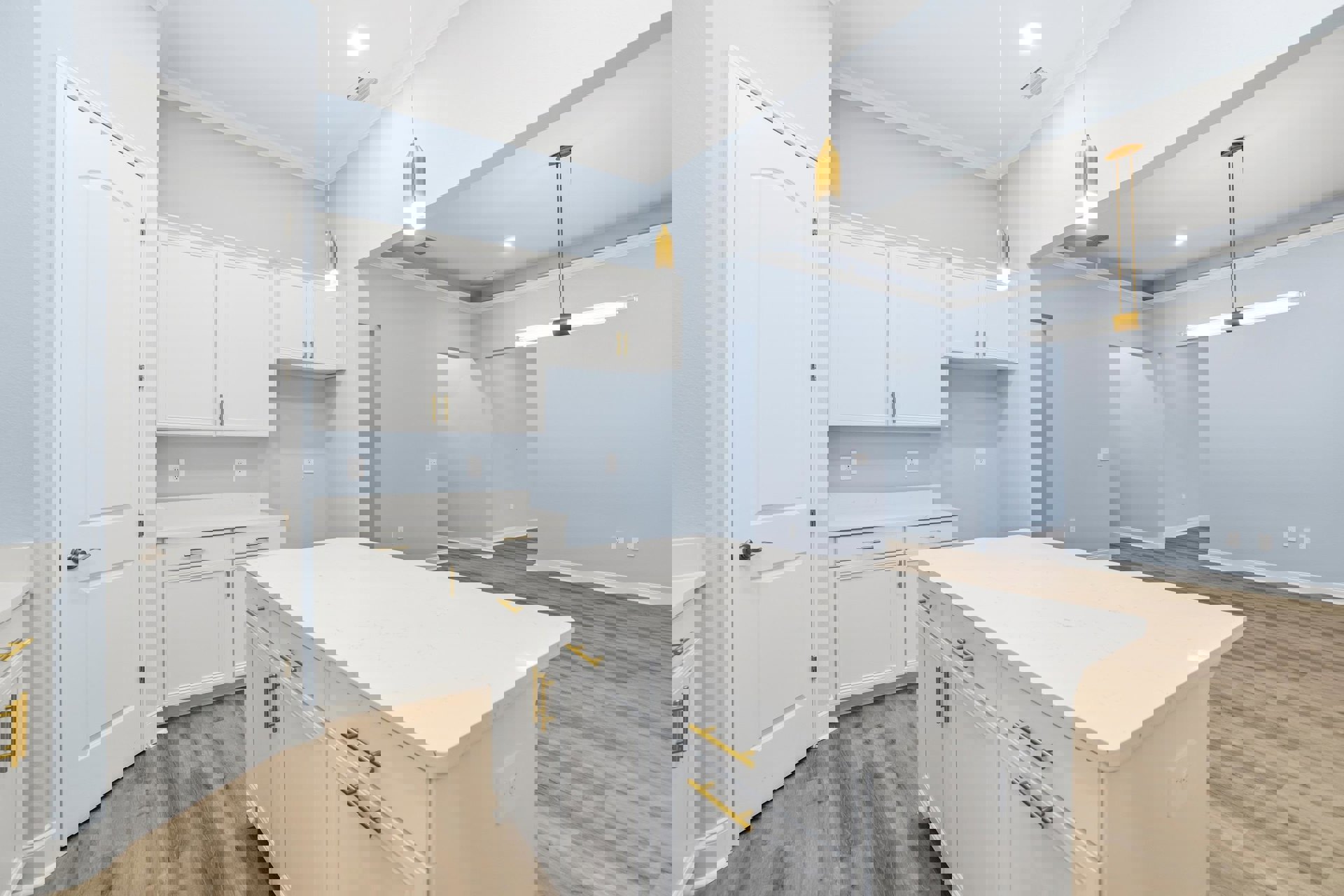 White kitchen with shaker cabinets, gold hardware, white quartz countertop, stainless steel sink, and integrated appliances.