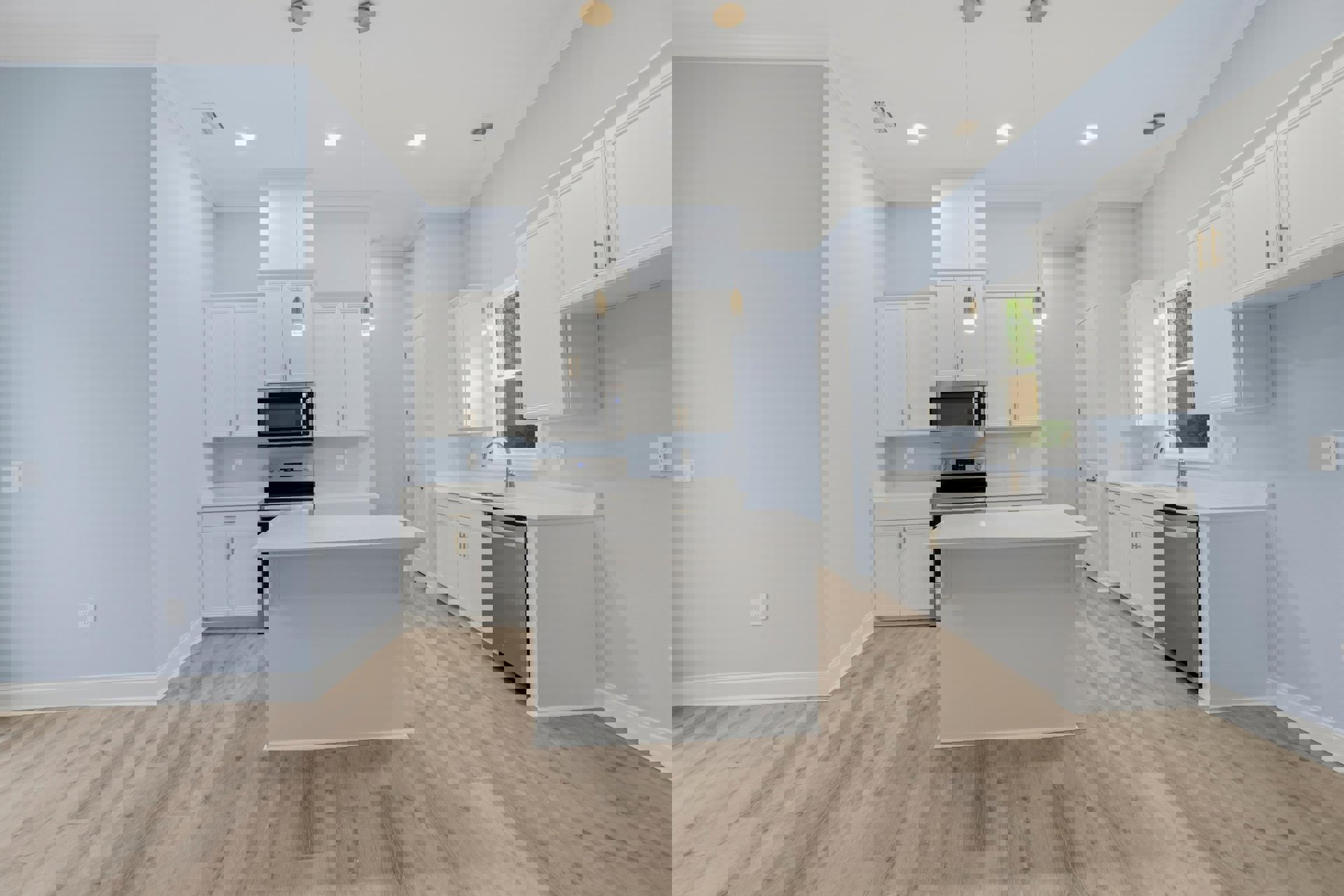 Kitchen with white shaker cabinets, wood plank flooring, white quartz countertops, stainless steel appliances, and a central white island