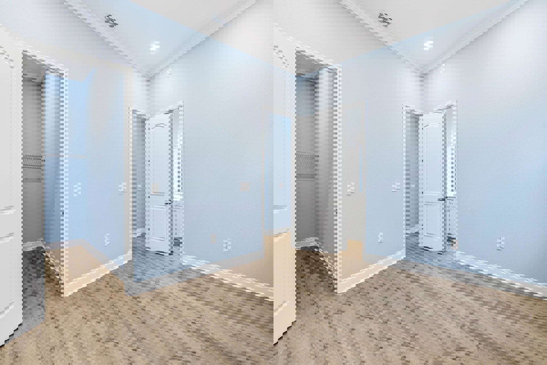 Blue walls, white door with silver handle, wood laminate flooring, ceiling vent and recessed light, simple modern interior