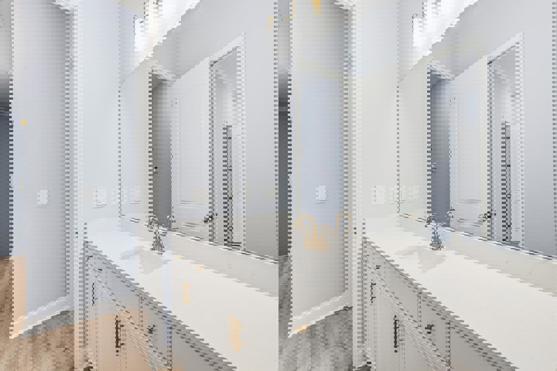 Bathroom featuring a white countertop with integrated sink, rectangular mirror above, white wall with light switch, and chrome faucet; black accent wall visible in background.