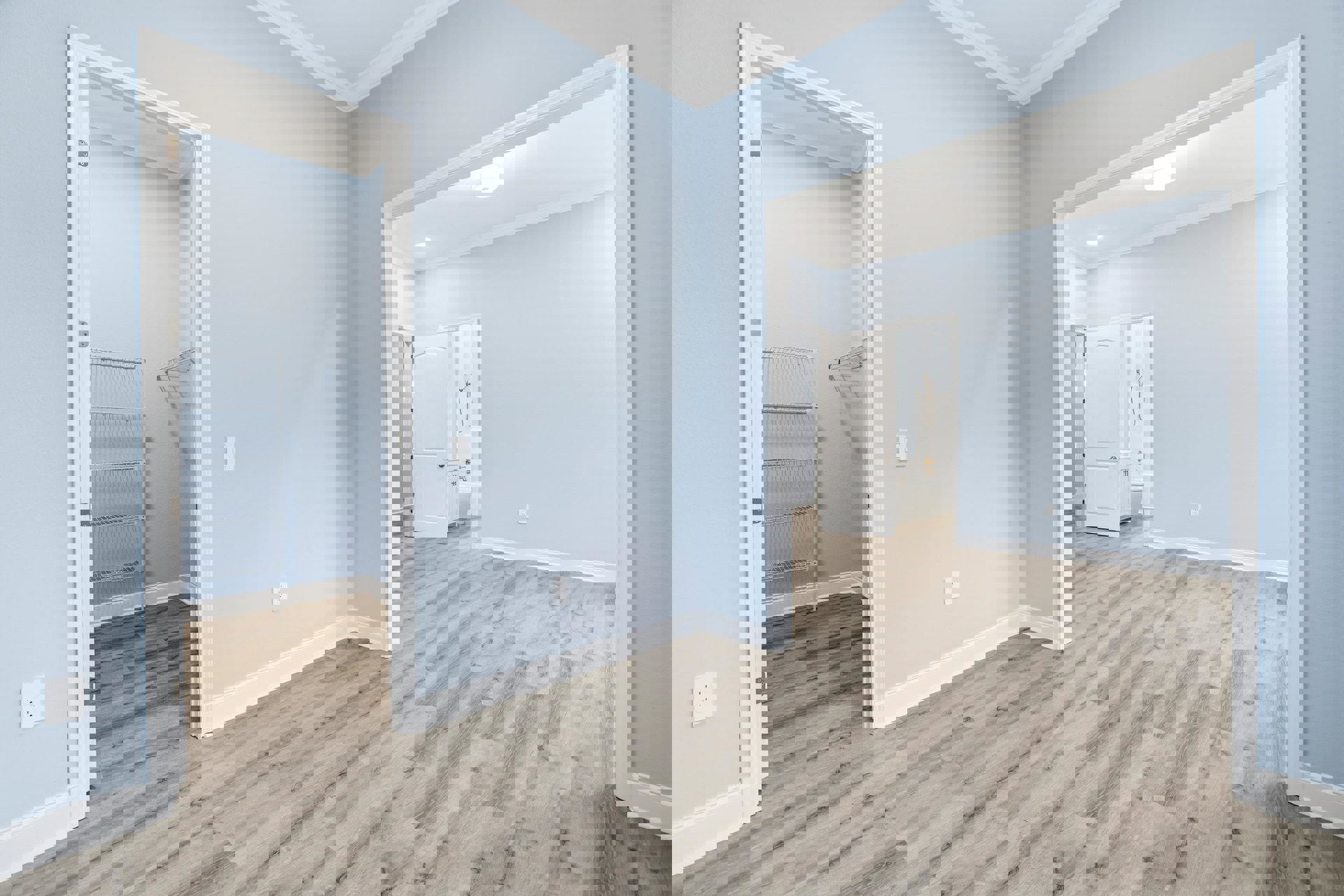 Wood floor with light blue walls, white shelf with metal rods, white electrical outlet, white door with silver handle