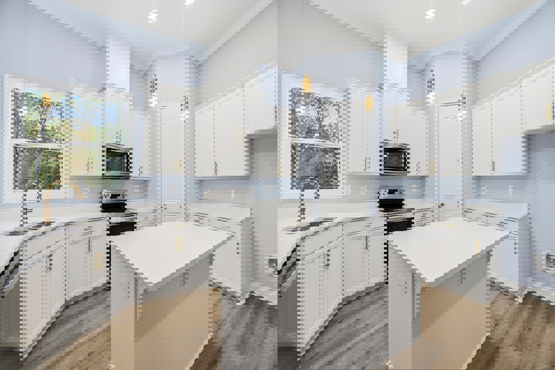 White cabinetry kitchen featuring a black stove, white countertop, built-in microwave, stainless steel faucet, window with tree view, and white door with black trim.