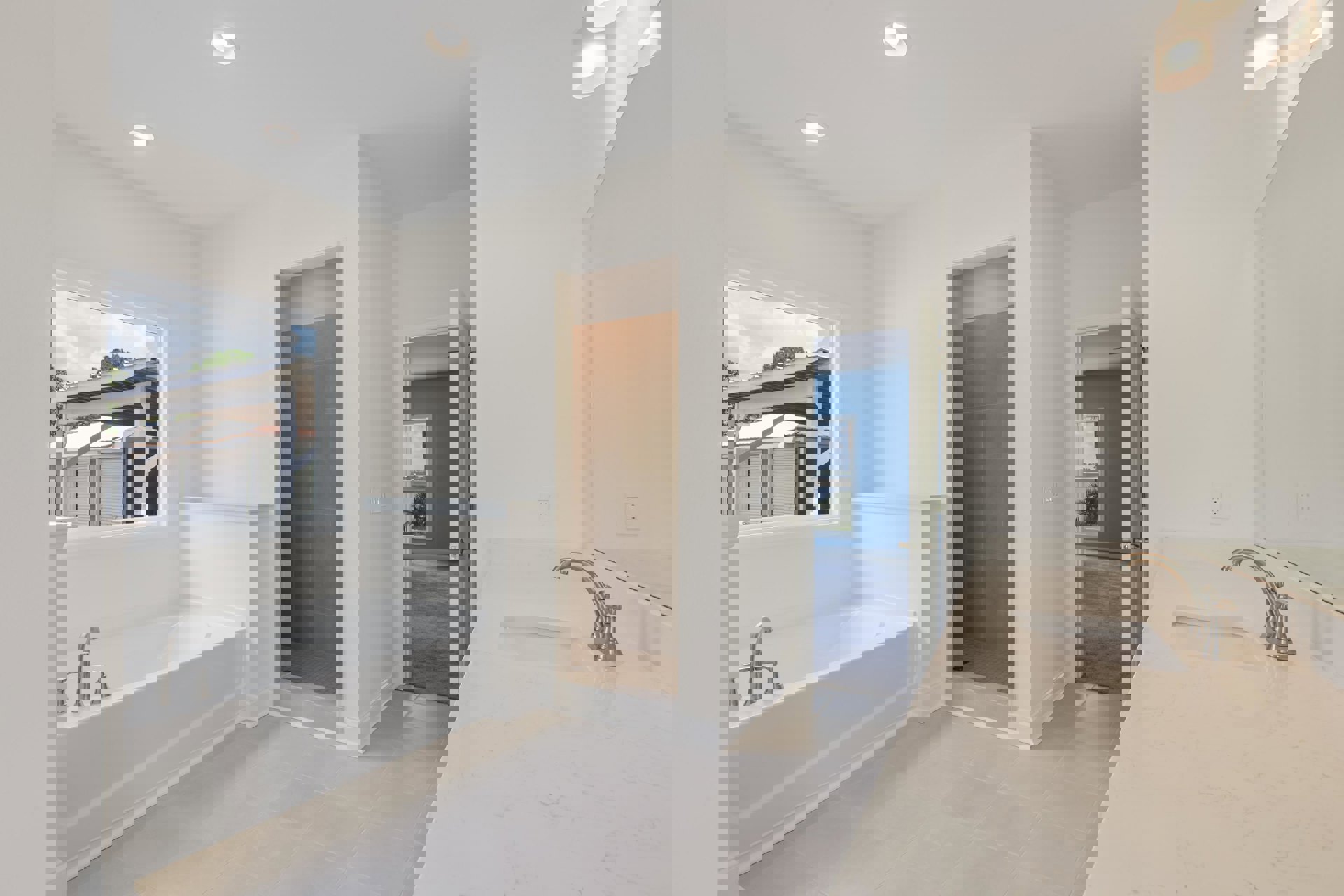 Modern bathroom featuring a white sink with chrome faucet, glass-enclosed shower, large window with white frame, light gray tile walls, and a freestanding bathtub.