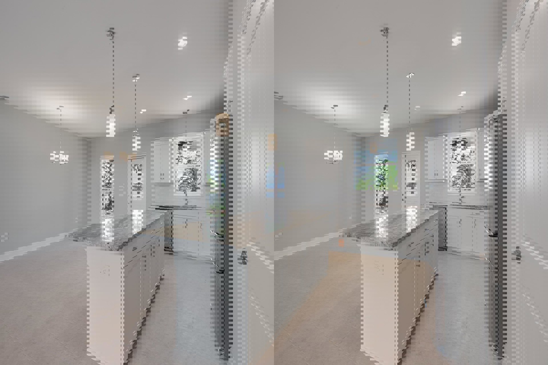 Marble kitchen island with waterfall edge, stainless steel refrigerator, white cabinetry, undermount sink, light wood flooring, ceiling fan, palm tree visible through glass door