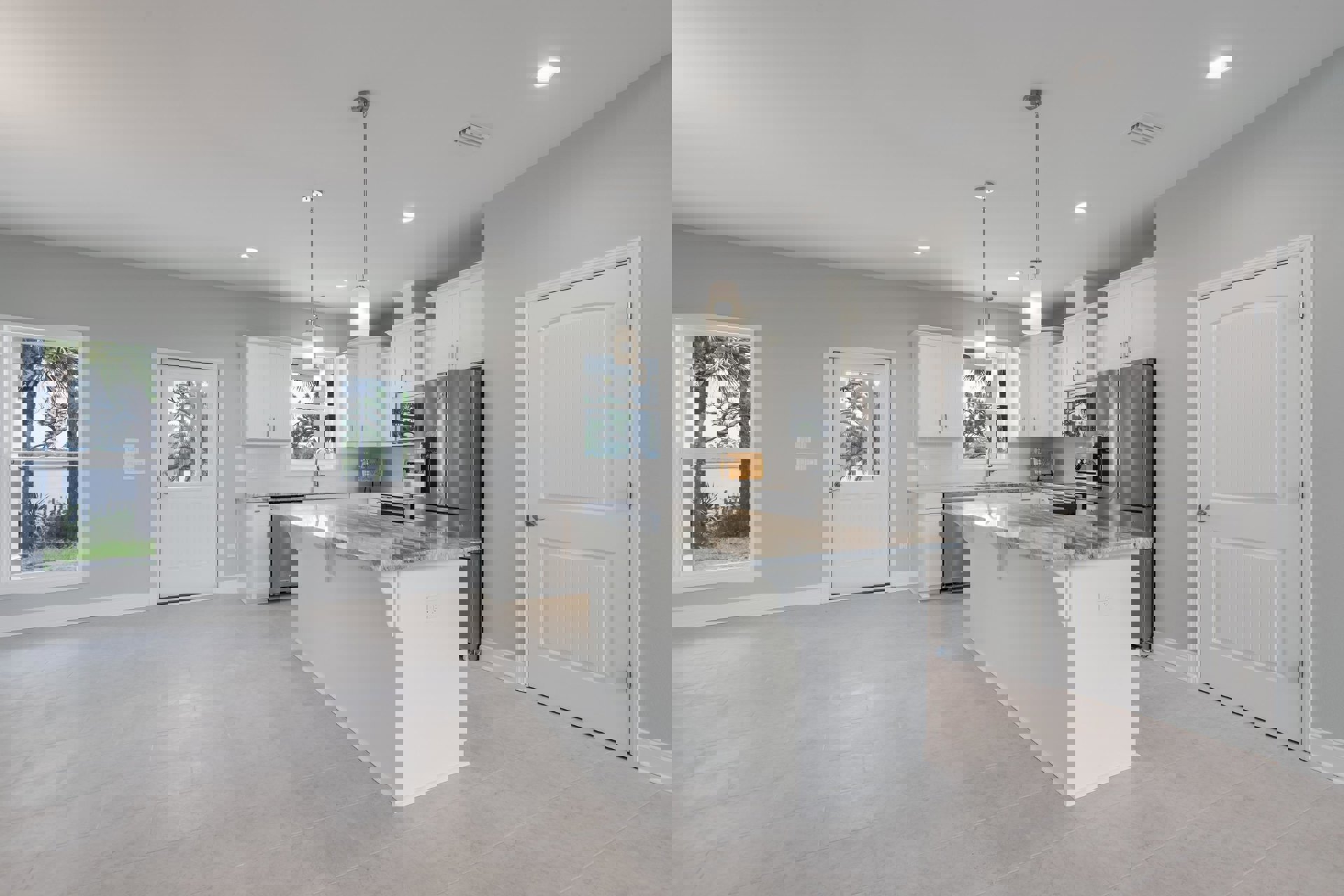 Spacious kitchen featuring a large marble-topped island, white cabinetry, stainless steel sink, ceiling light fixture, white door with a window and silver handle, and a window