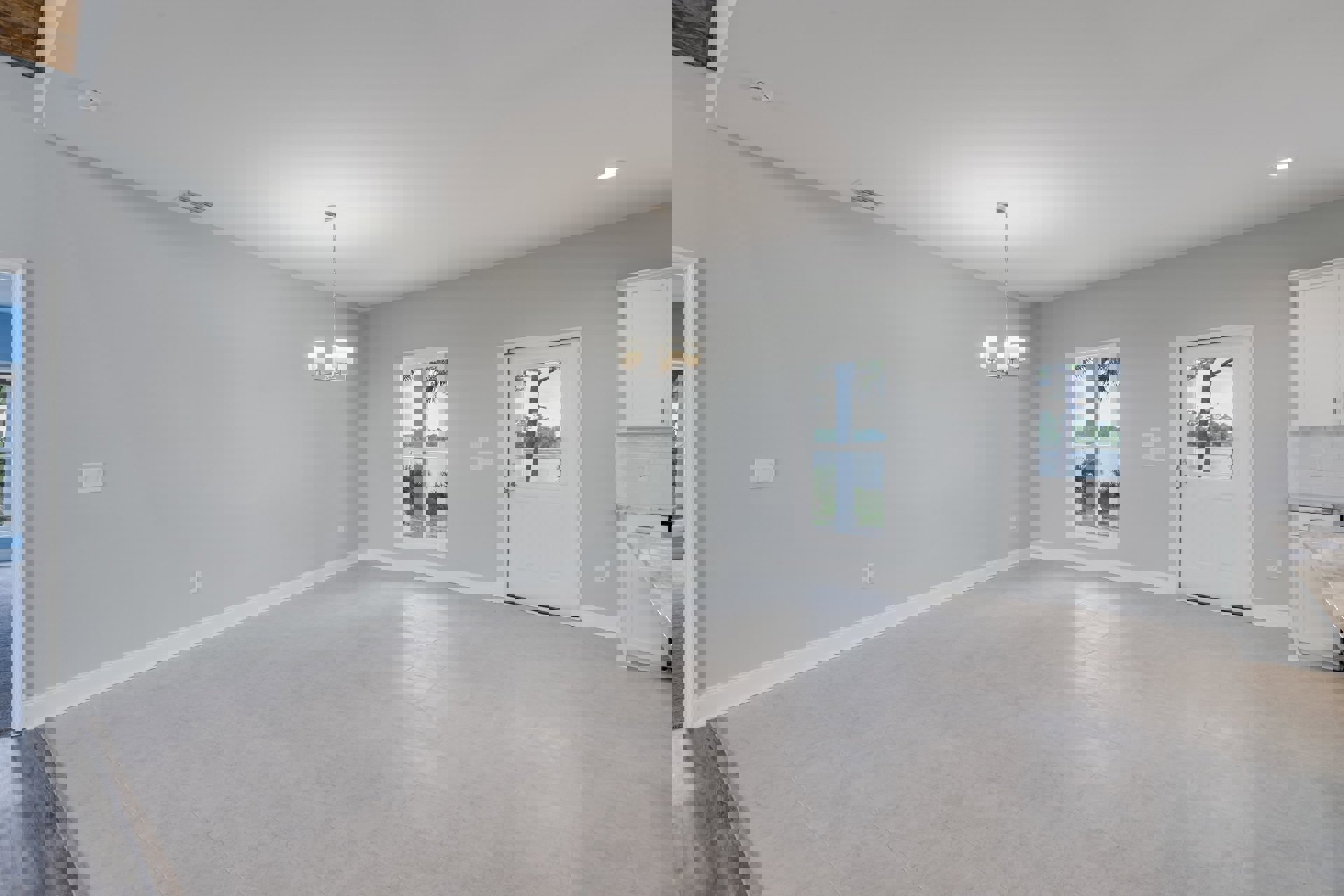 White tile floor in a bright room with a white door featuring a glass window, large windows showing palm trees outside, smooth plaster walls, and a ceiling light fixture.