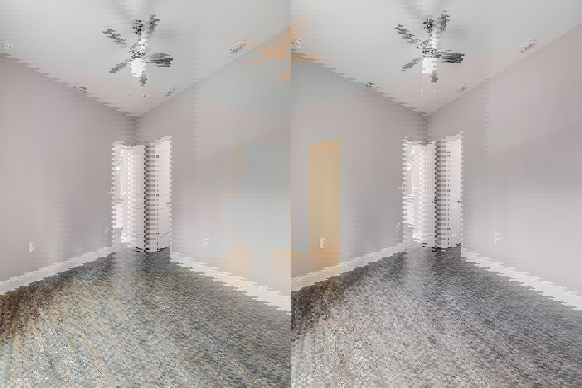 Ceiling fan with light fixture above wood flooring, two white doors with silver metal doorknobs, white walls and crown molding.