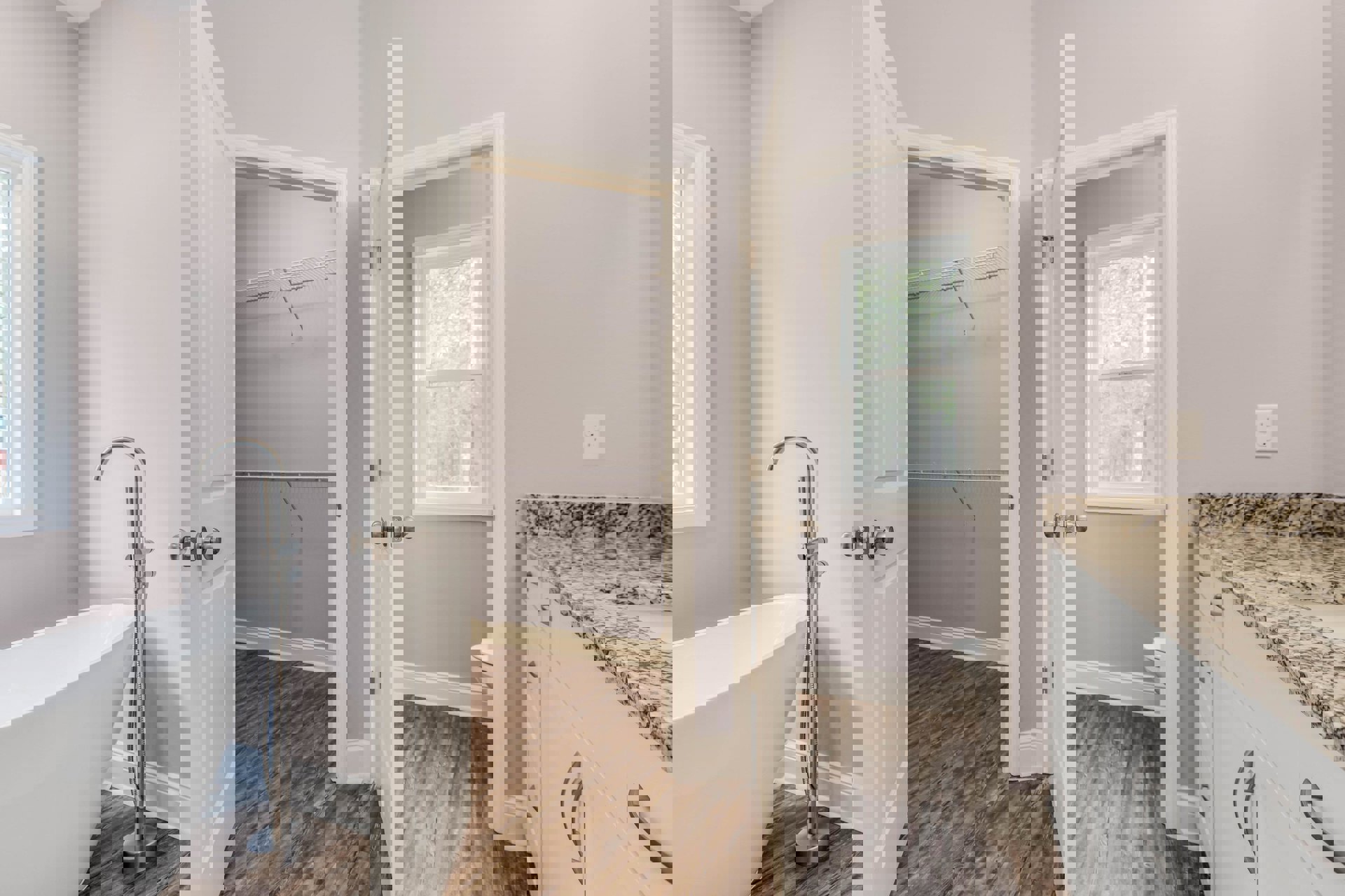 Modern bathroom featuring a freestanding white bathtub beside a glass-enclosed shower, white sink with chrome faucet, light-colored tile flooring, white walls, and a window