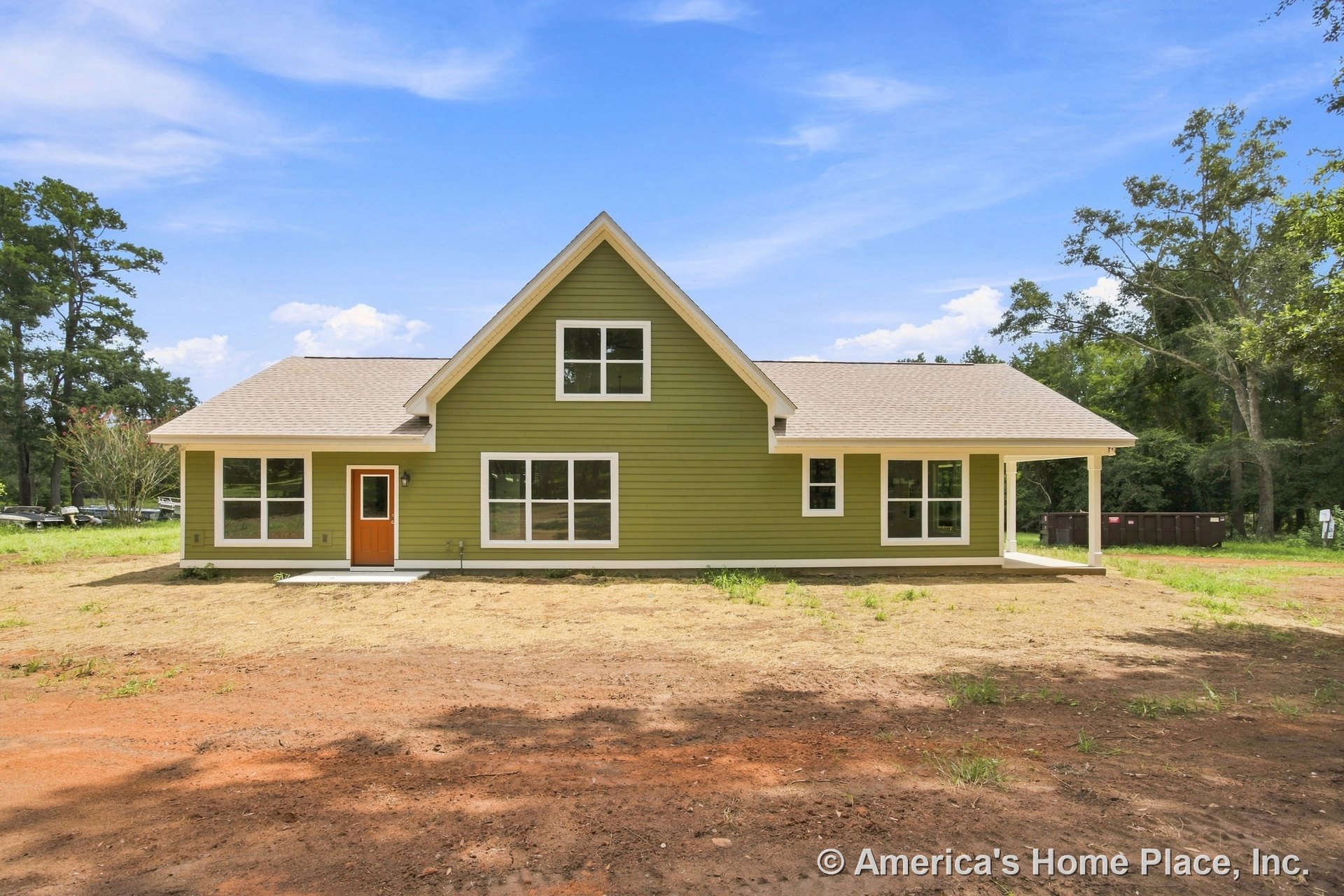 Green horizontal lap siding with white trim, gable roof, multiple large windows, covered front porch, and orange front door on new residential exterior.