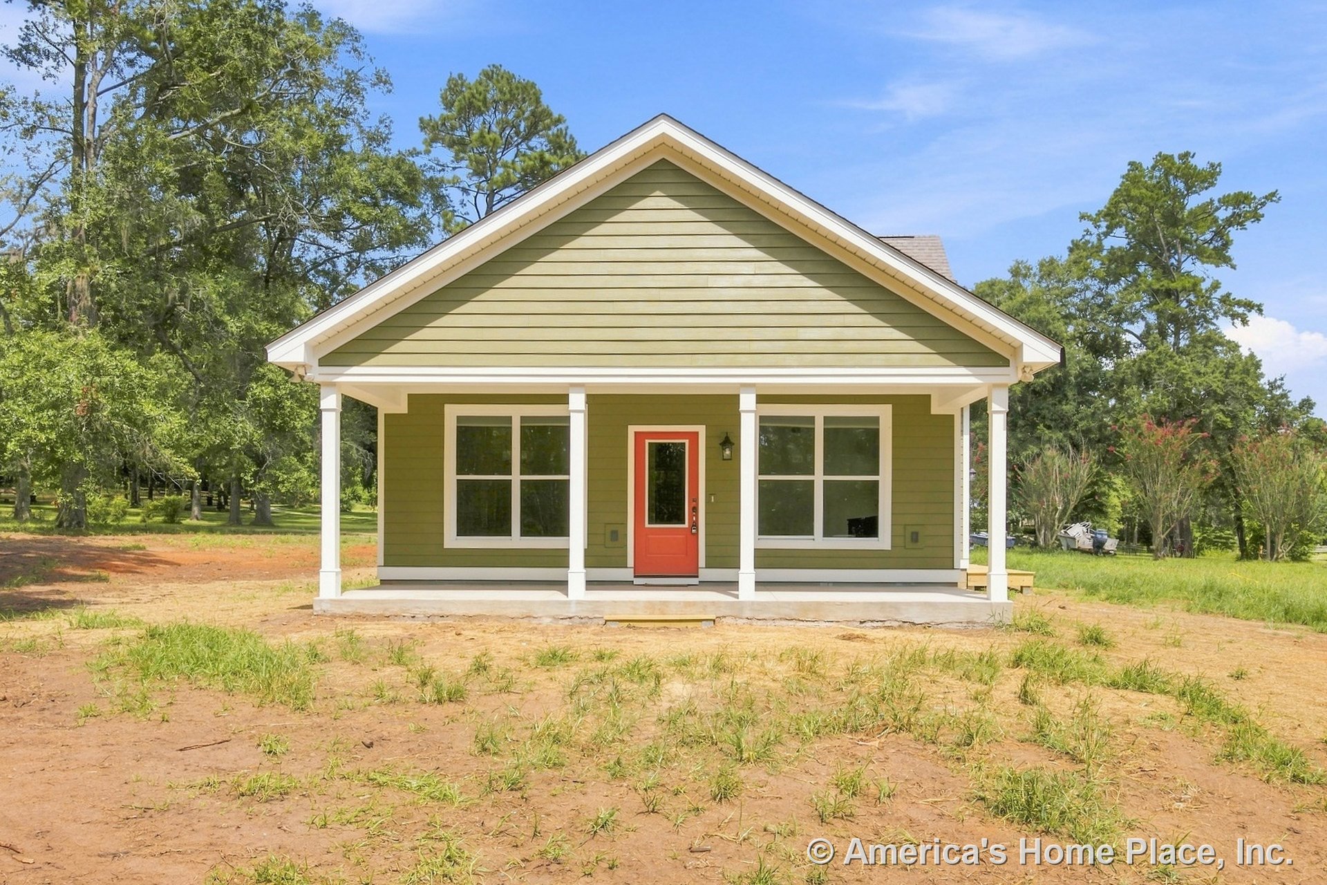 Covered front porch with four white columns, red entry door, green horizontal siding, white trim, large front windows, gable roof, and concrete porch floor