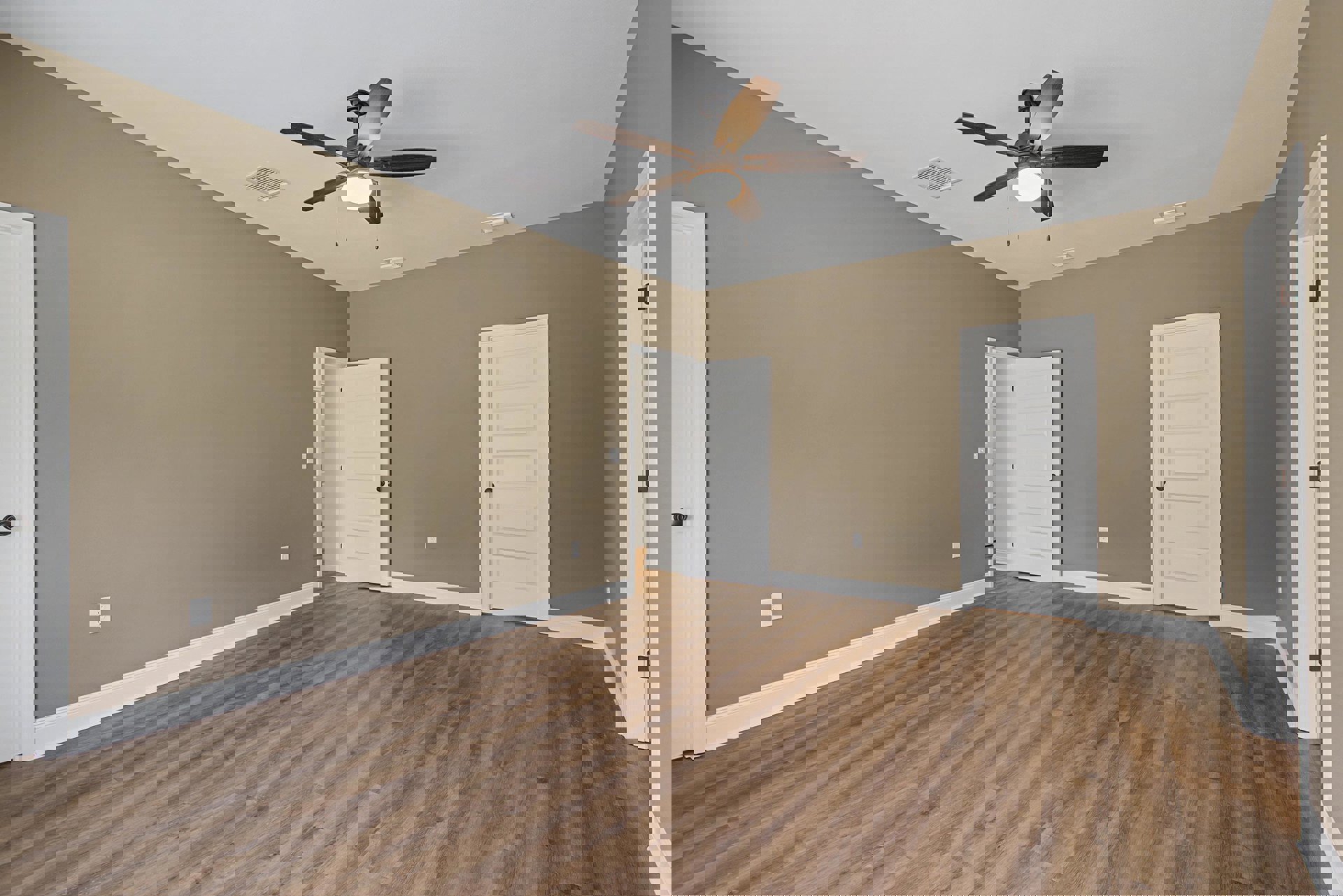 Ceiling fan with light fixture, white walls with black trim, wood flooring, two white doors with black handles