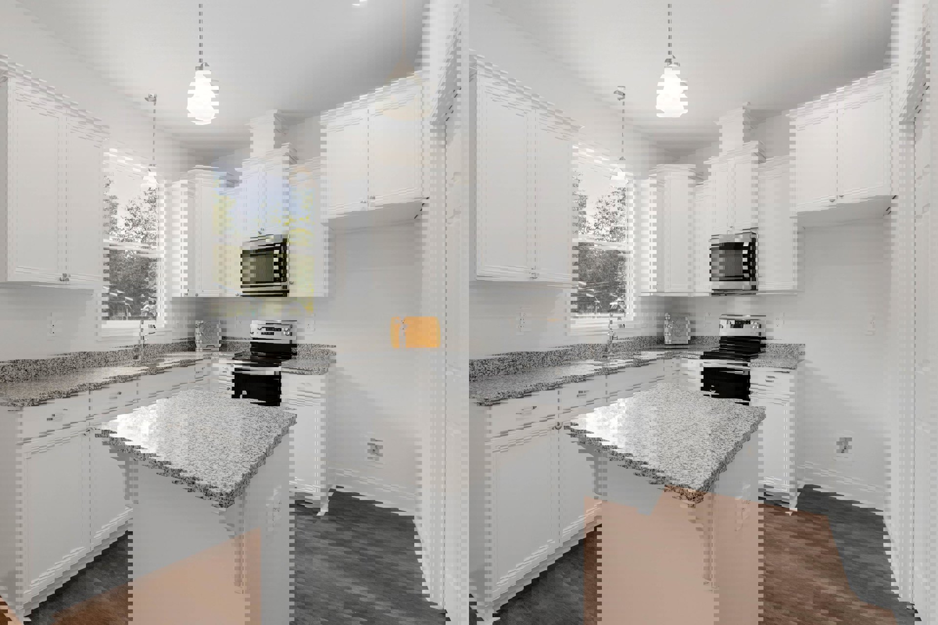 Granite countertops, black stove, glass-door microwave, open oven, ceiling light fixture, wooden cutting board with bow, white cabinetry, stainless steel sink