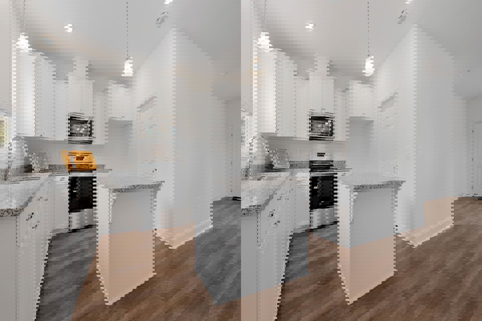 White kitchen with shaker cabinets, black stove with glass door, marble-topped island, stainless steel microwave, wooden cutting board with ribbon, metal pole on countertop