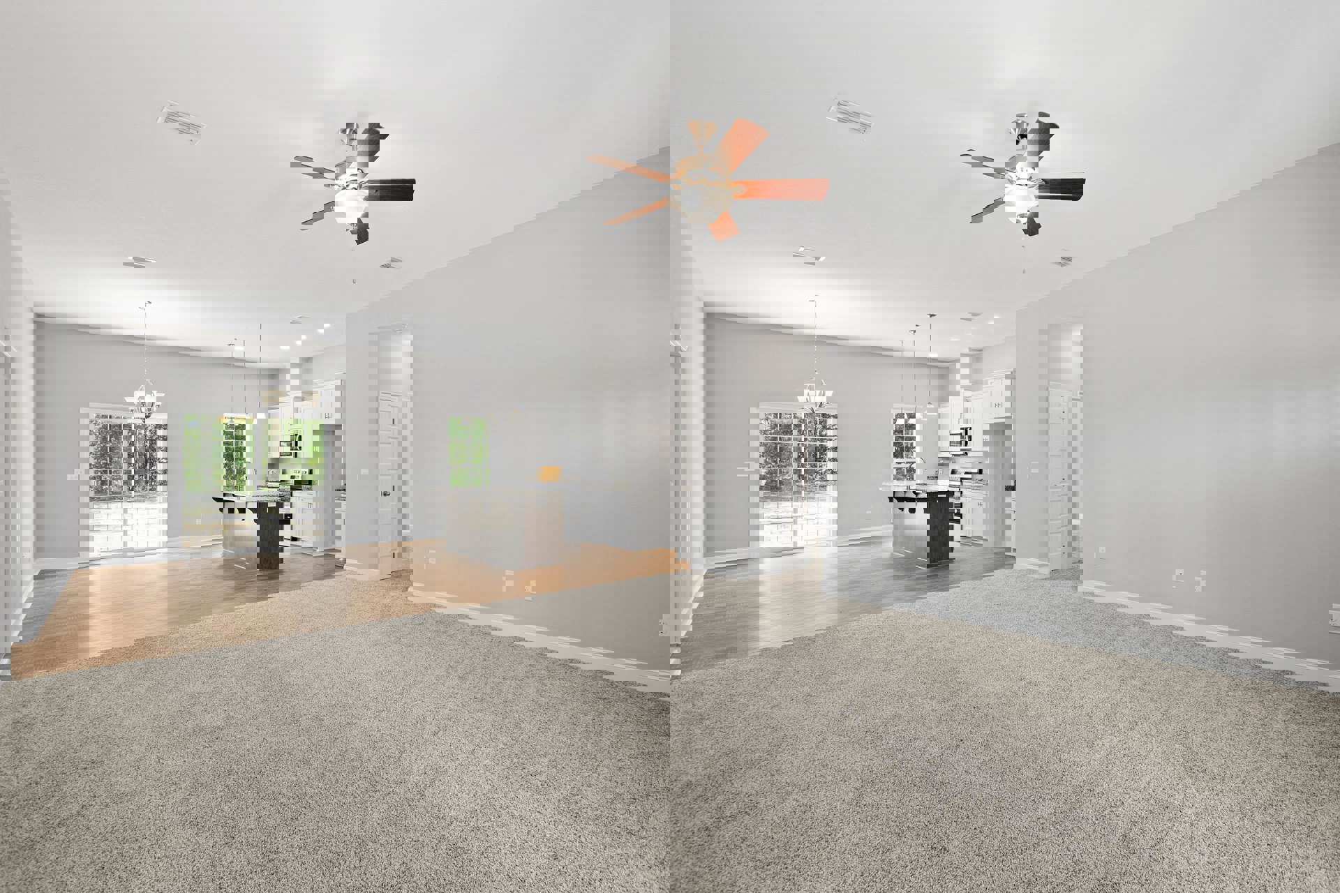 Open concept living room with carpet flooring, ceiling fan with light fixture, adjacent kitchen featuring marble countertop island, glass door, and laminate floors