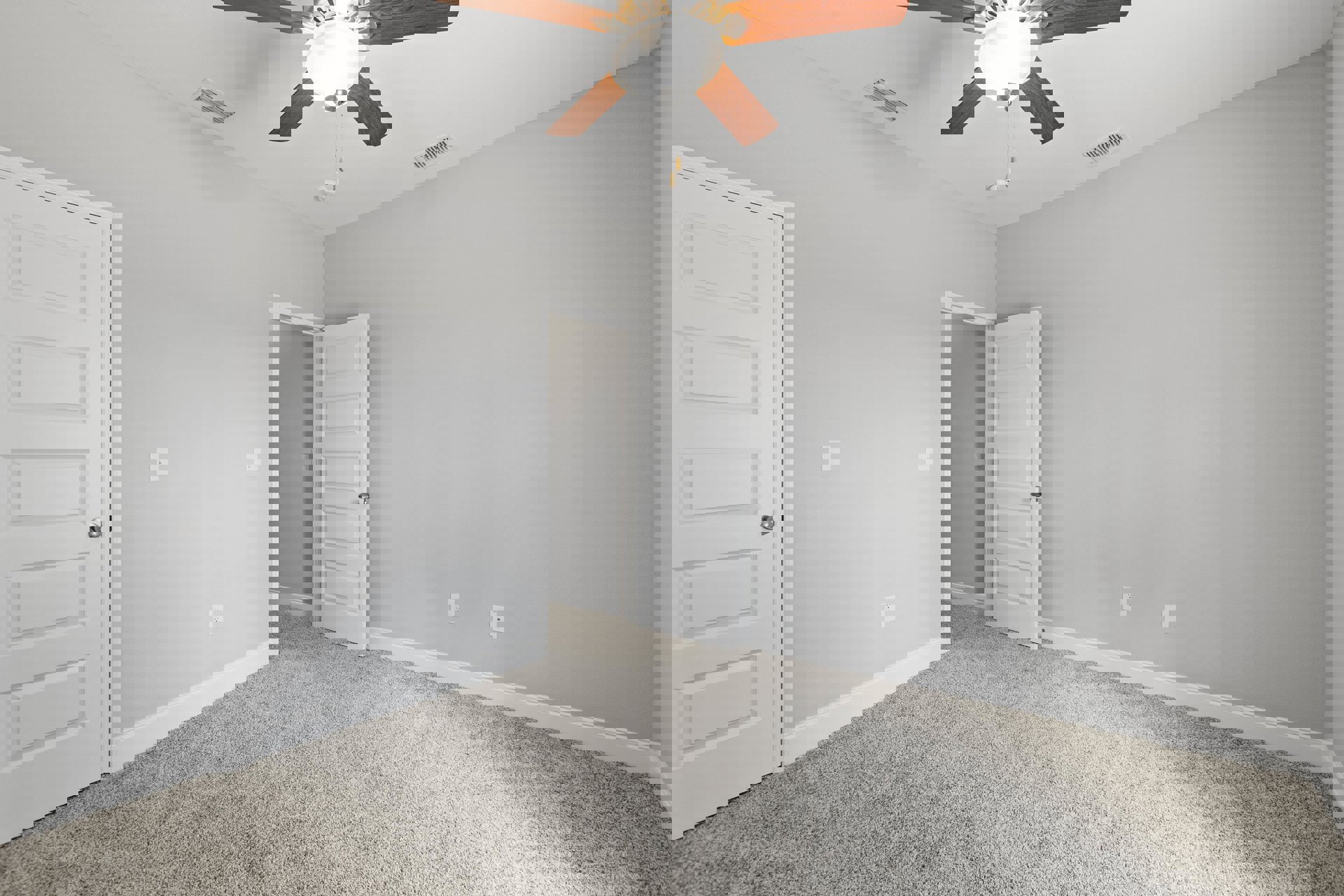 Ceiling fan with light fixture mounted on white plaster ceiling, white door with silver handle, vent, and baseboard molding in a residential room with neutral flooring