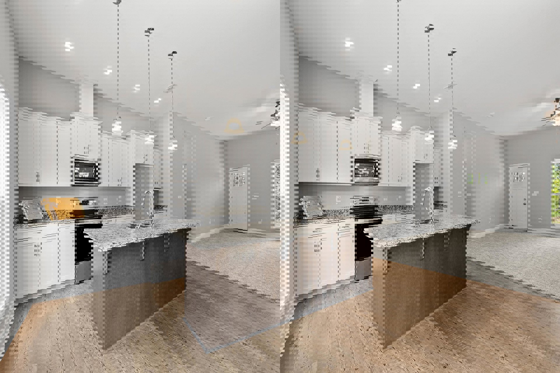 Spacious kitchen featuring a large central island with granite countertops, white cabinetry, stainless steel sink, wooden flooring, and a white door with a black handle and window