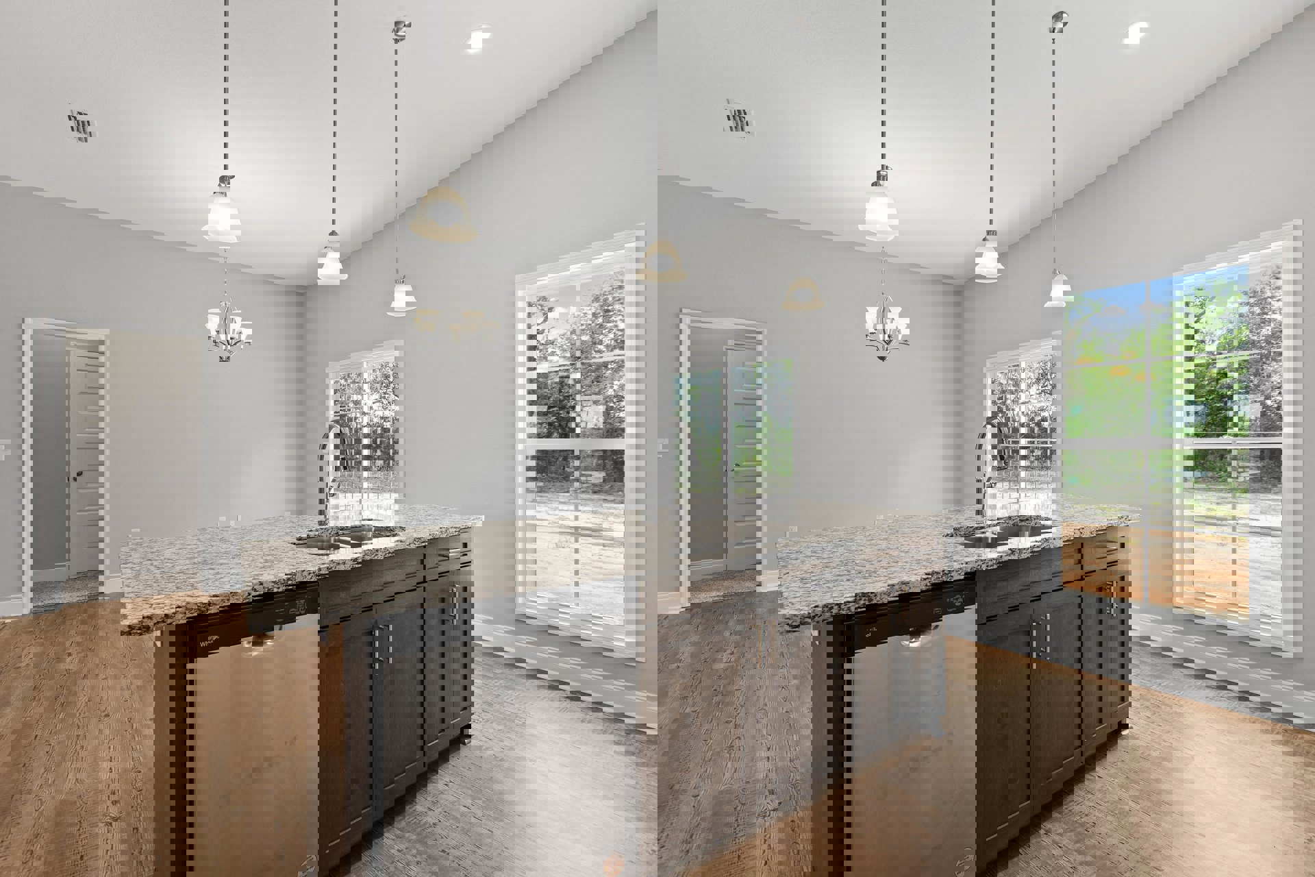 Modern kitchen featuring white cabinetry, stainless steel sink and dishwasher, stone countertop, window overlooking outdoors, and white door with silver doorknob