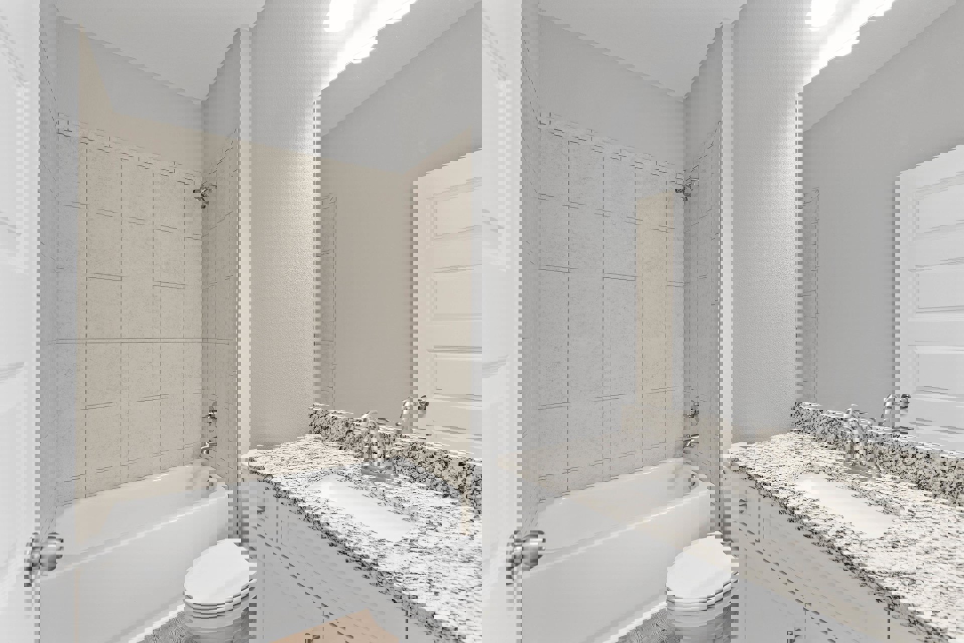 Bathroom with white toilet, rectangular sink on stone countertop, white bathtub with tiled wall surround, white door, chrome faucet