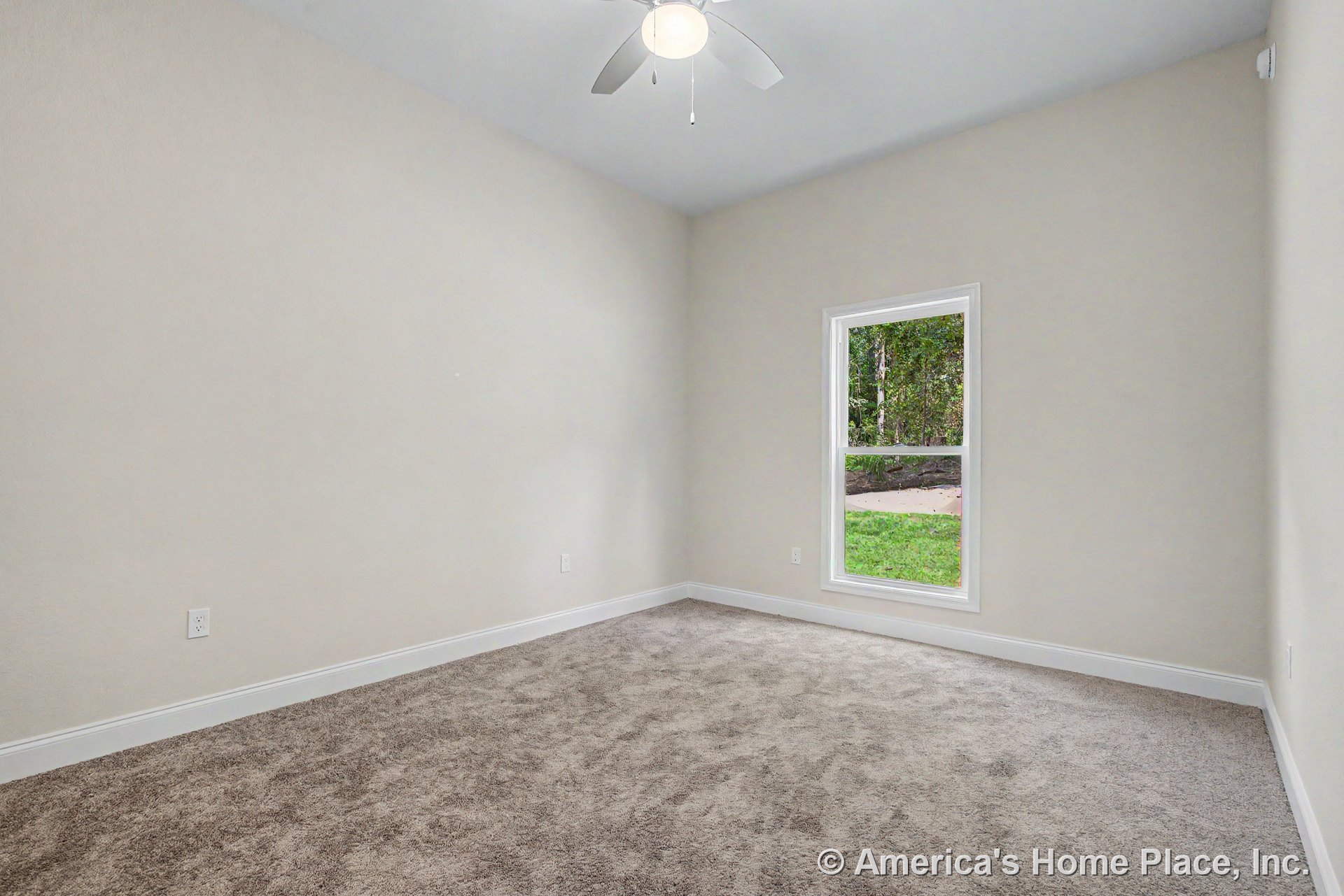 Light beige carpet flooring, white baseboards, neutral painted walls, single window with trim, ceiling fan and light fixture, standard ceiling height in empty bedroom.