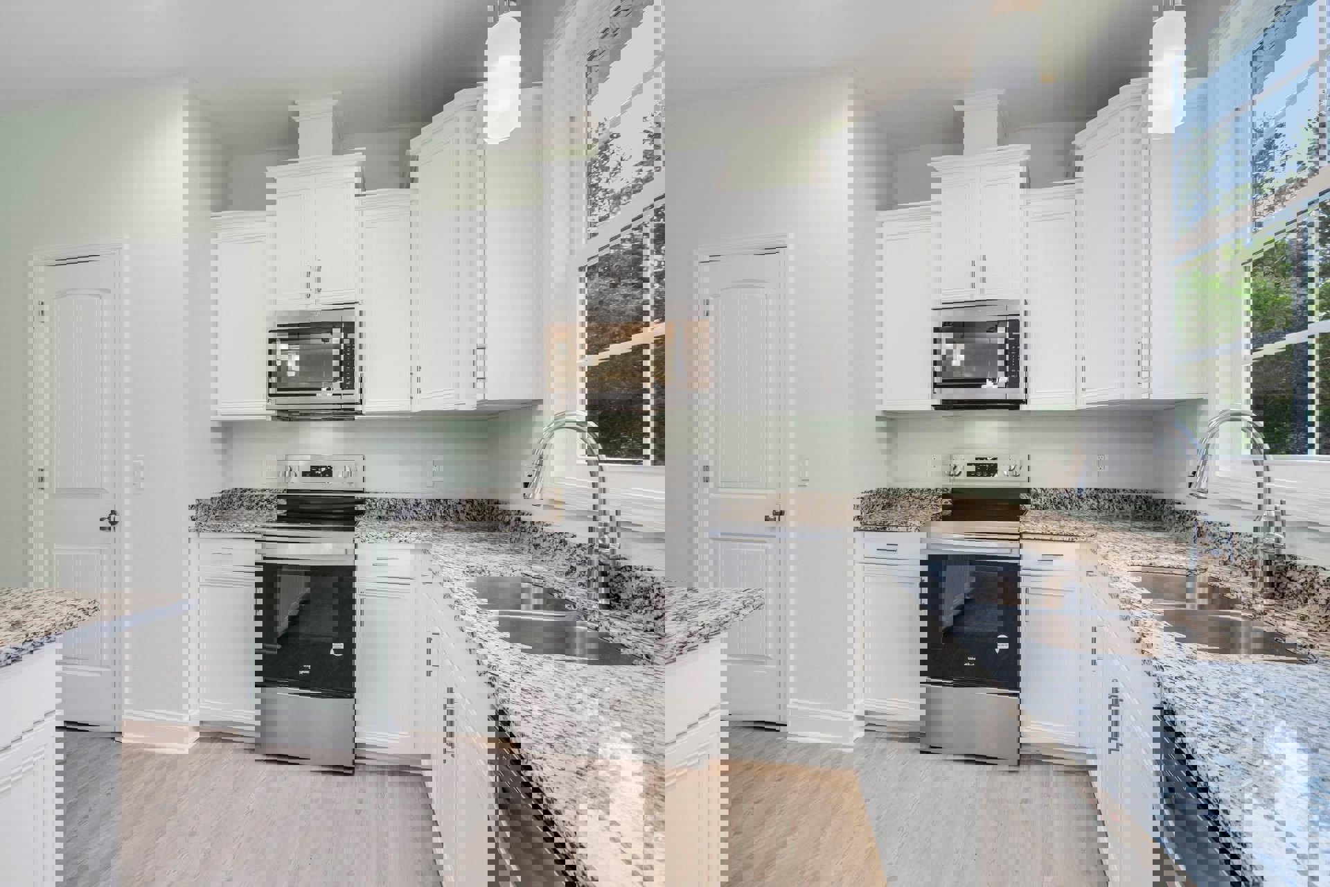 White kitchen cabinets with granite countertops, stainless steel stove and microwave, under-cabinet lighting, white door with silver knob