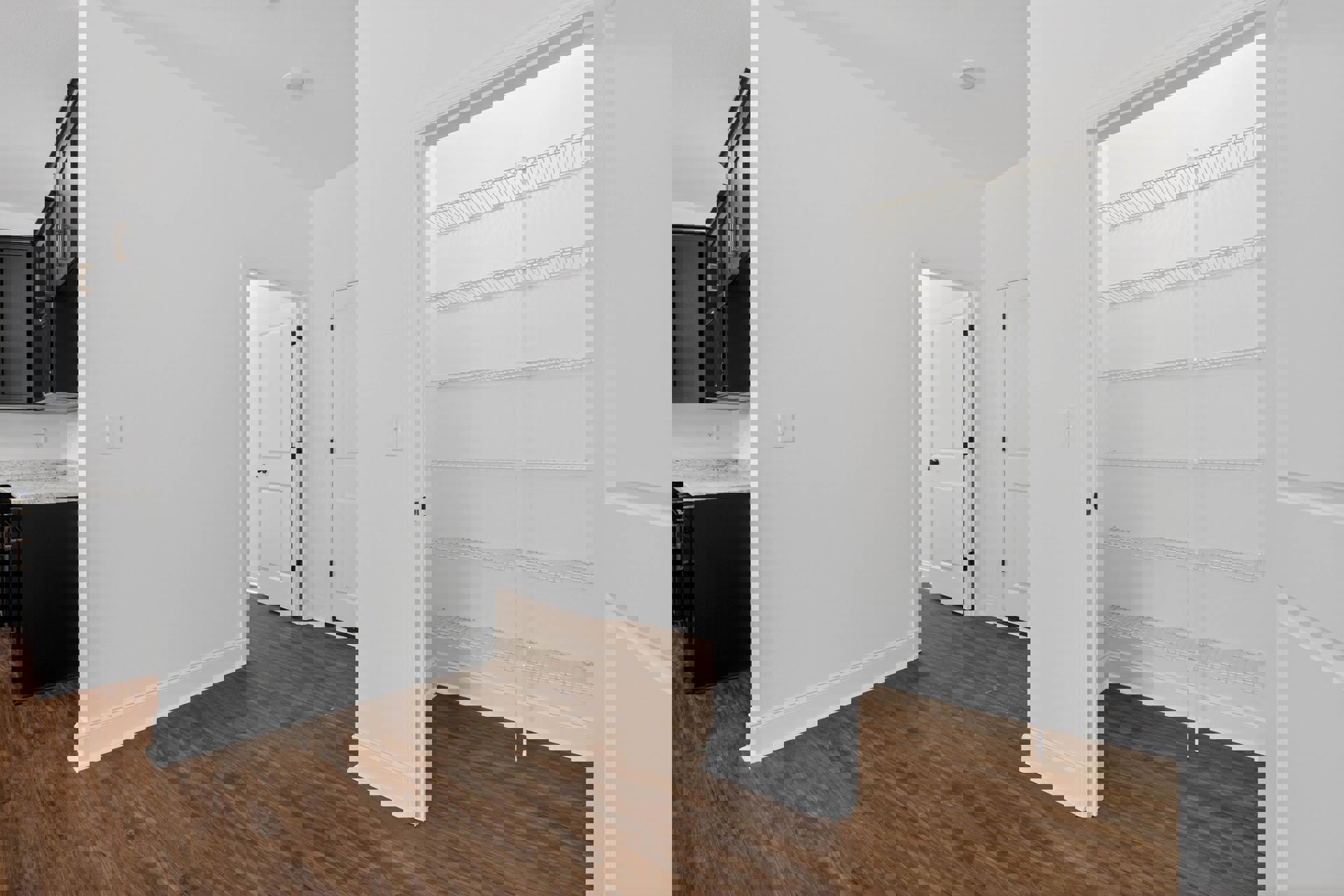 White walls and wood flooring, black cabinet with marble countertop, empty white closet with built-in shelves, white door with black knob