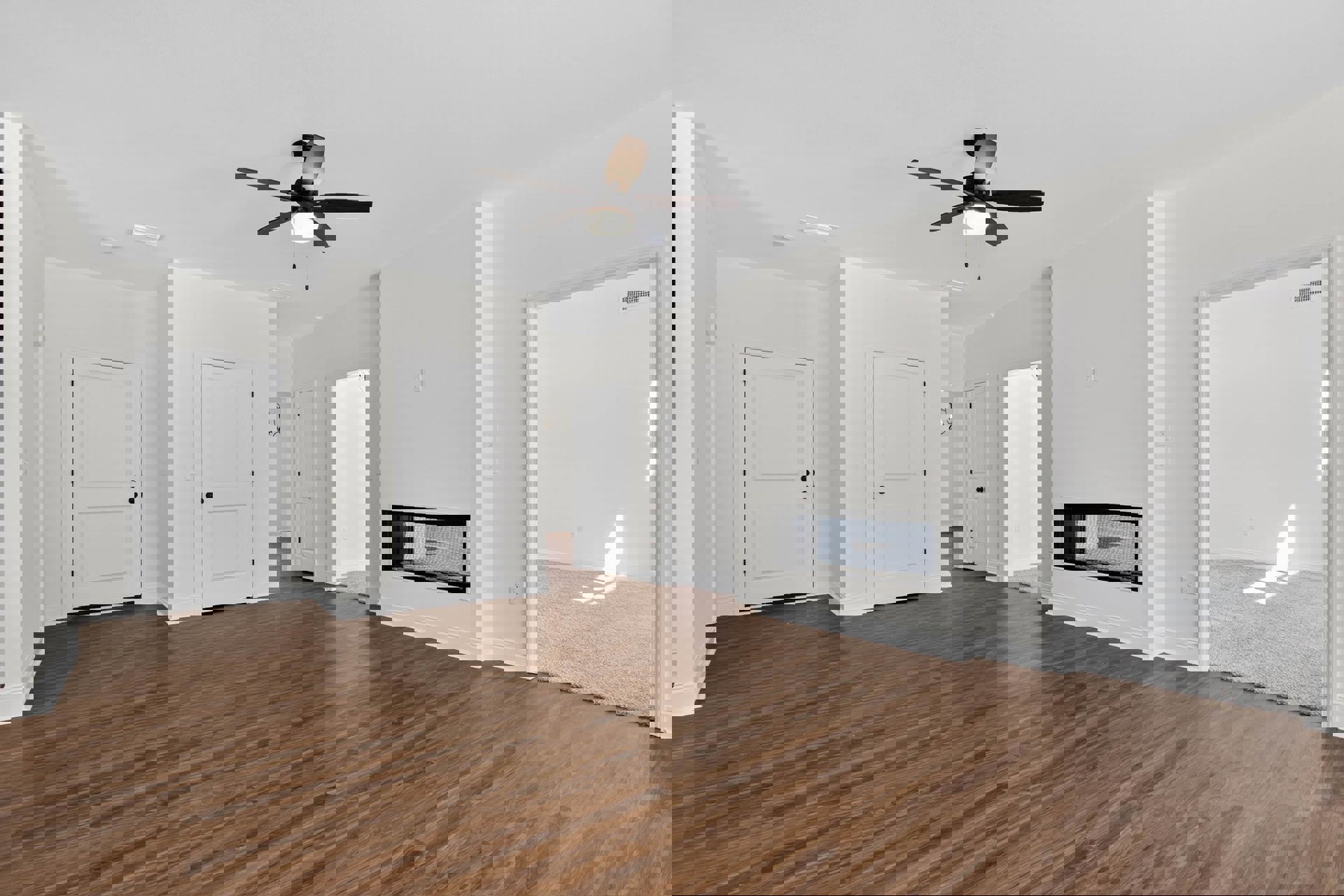 White walls, hardwood floor, ceiling fan with light, black-framed window, white door with black knobs, open doorway in a bright interior room