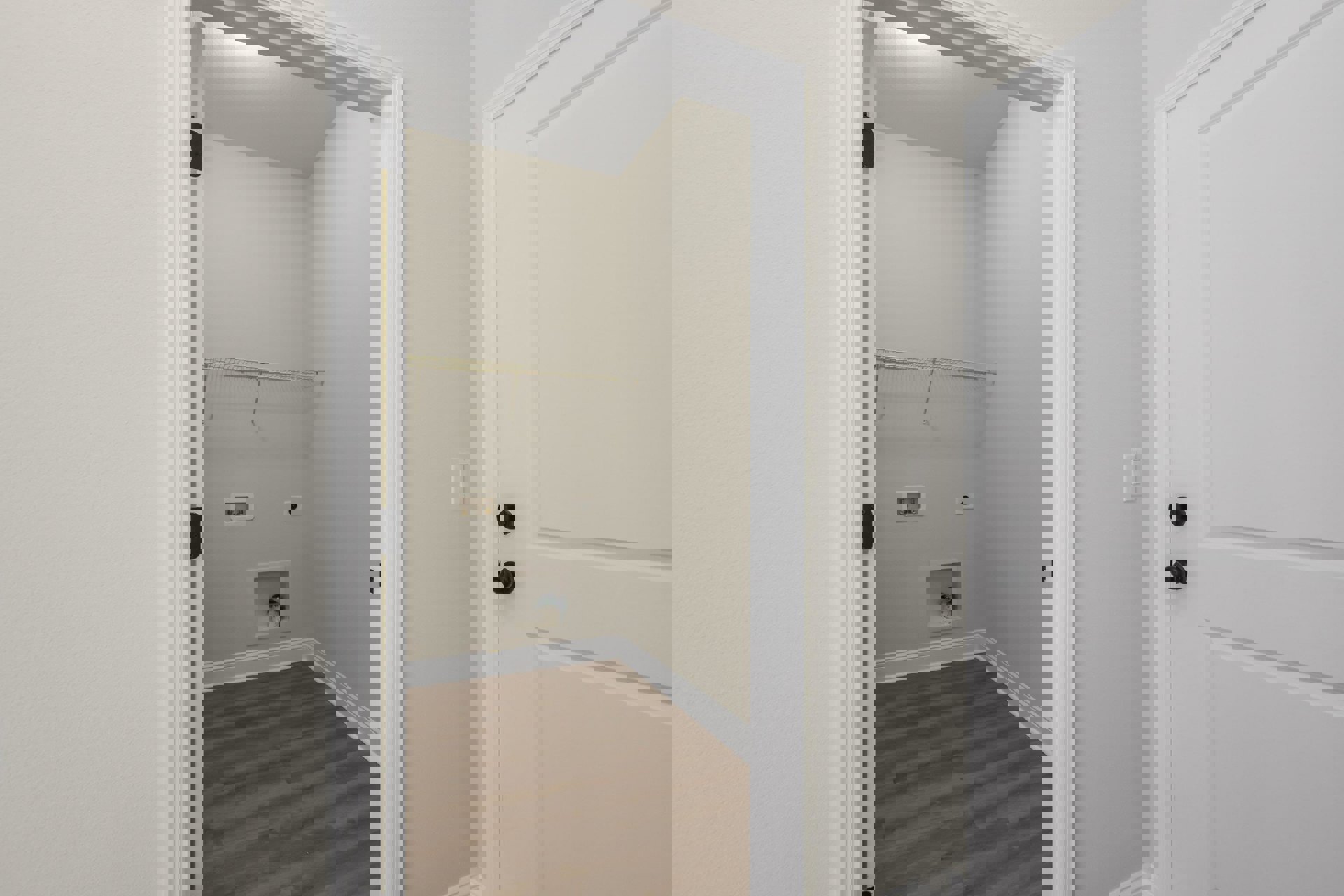 Wood floor with white baseboards, white door featuring black knobs, closet with built-in shelves and a white candle, smooth white walls