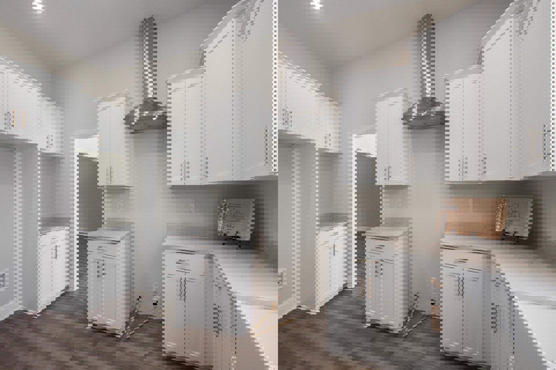 Kitchen with white shaker cabinets, silver handles, wood flooring, stainless steel range hood, and light countertops
