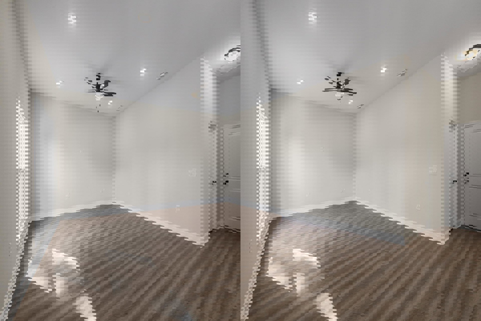 Ceiling fan with light fixture mounted on white plaster ceiling, wood laminate flooring, white door with glass window, neutral walls in residential interior.