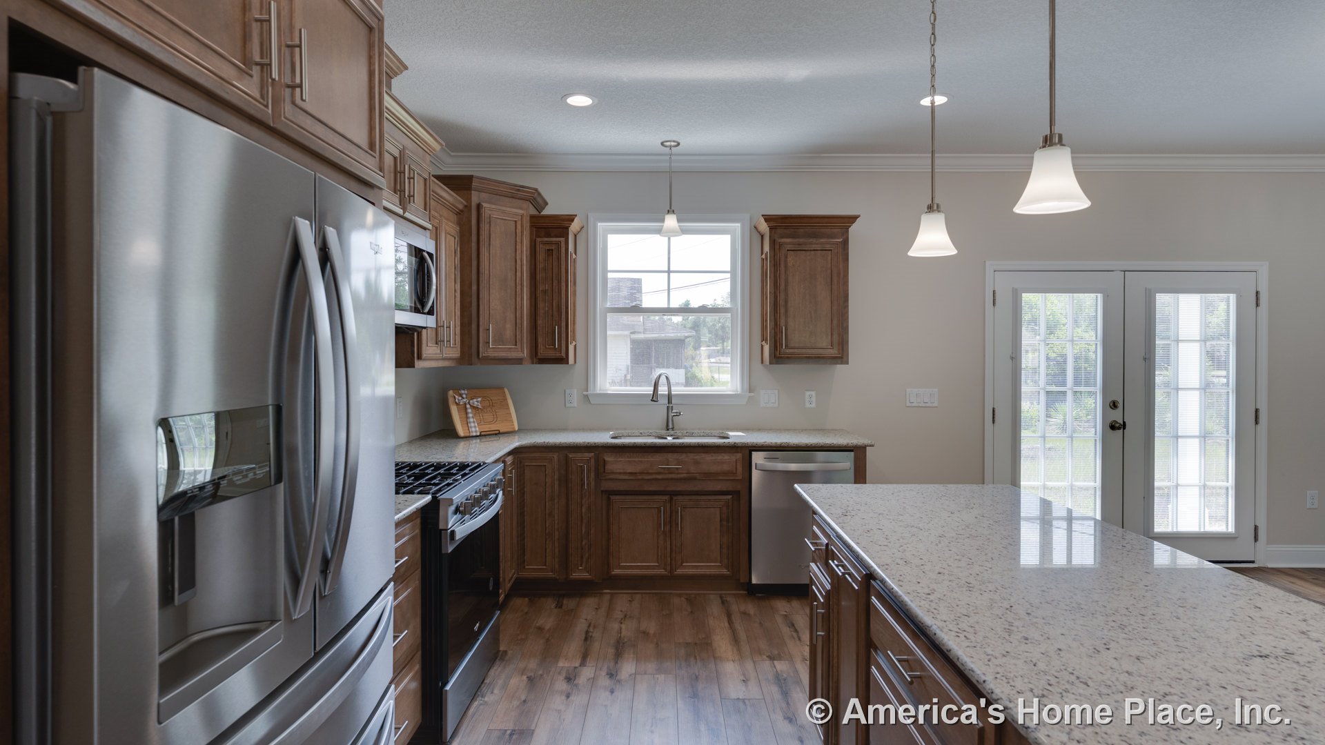 Wood cabinetry kitchen with granite island countertop, stainless steel refrigerator, gas range, built-in microwave, dishwasher, pendant lighting fixtures, double French doors