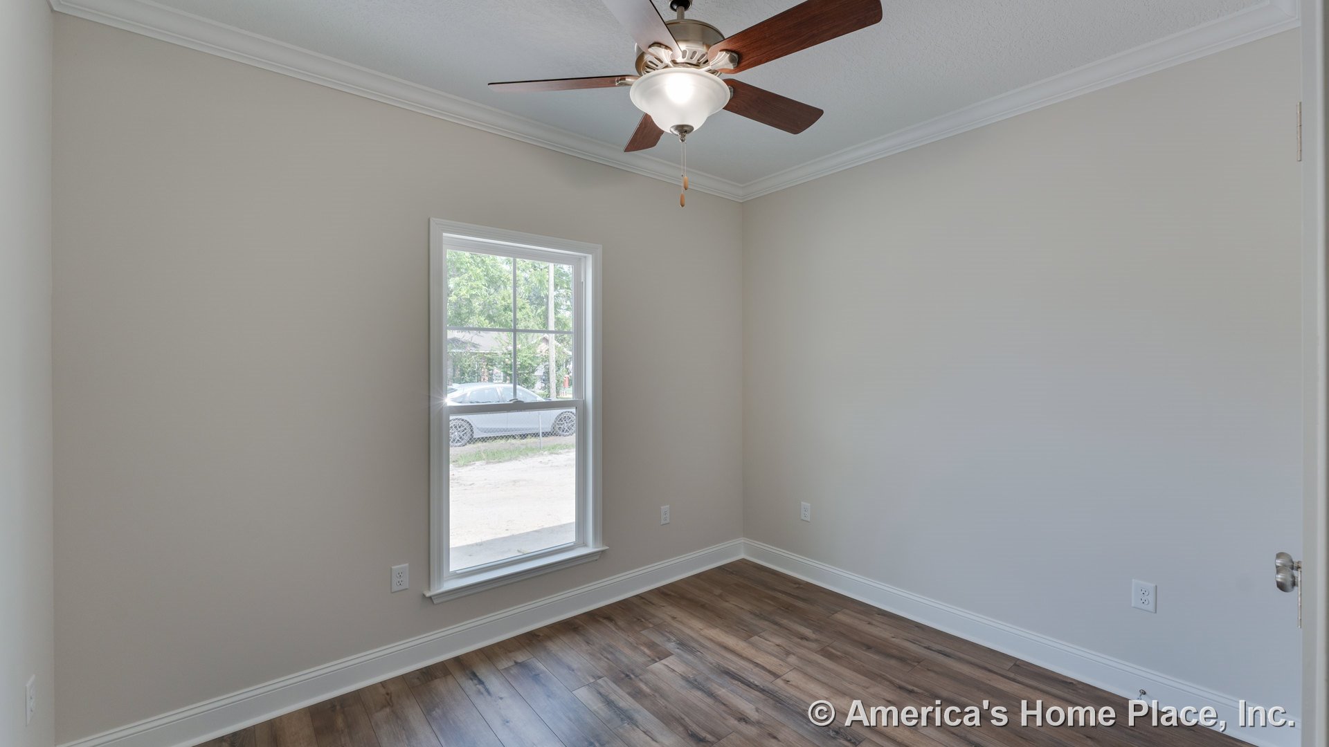 Small bedroom with wood-look plank flooring, white crown molding, single window with trim, ceiling fan and light fixture, neutral wall paint, and white baseboards.