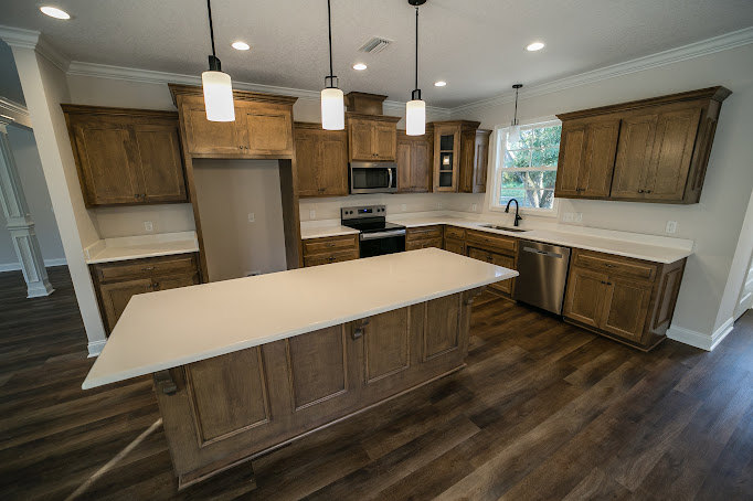 Kitchen featuring light wooden cabinets, white quartz countertop, neutral tile backsplash, and recessed lighting