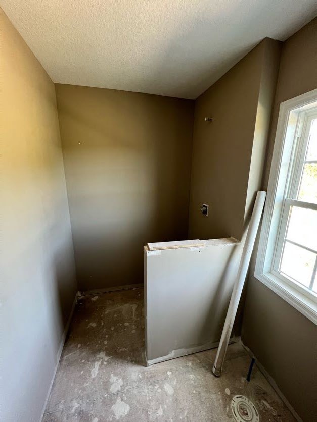 A room with a window and a wall.